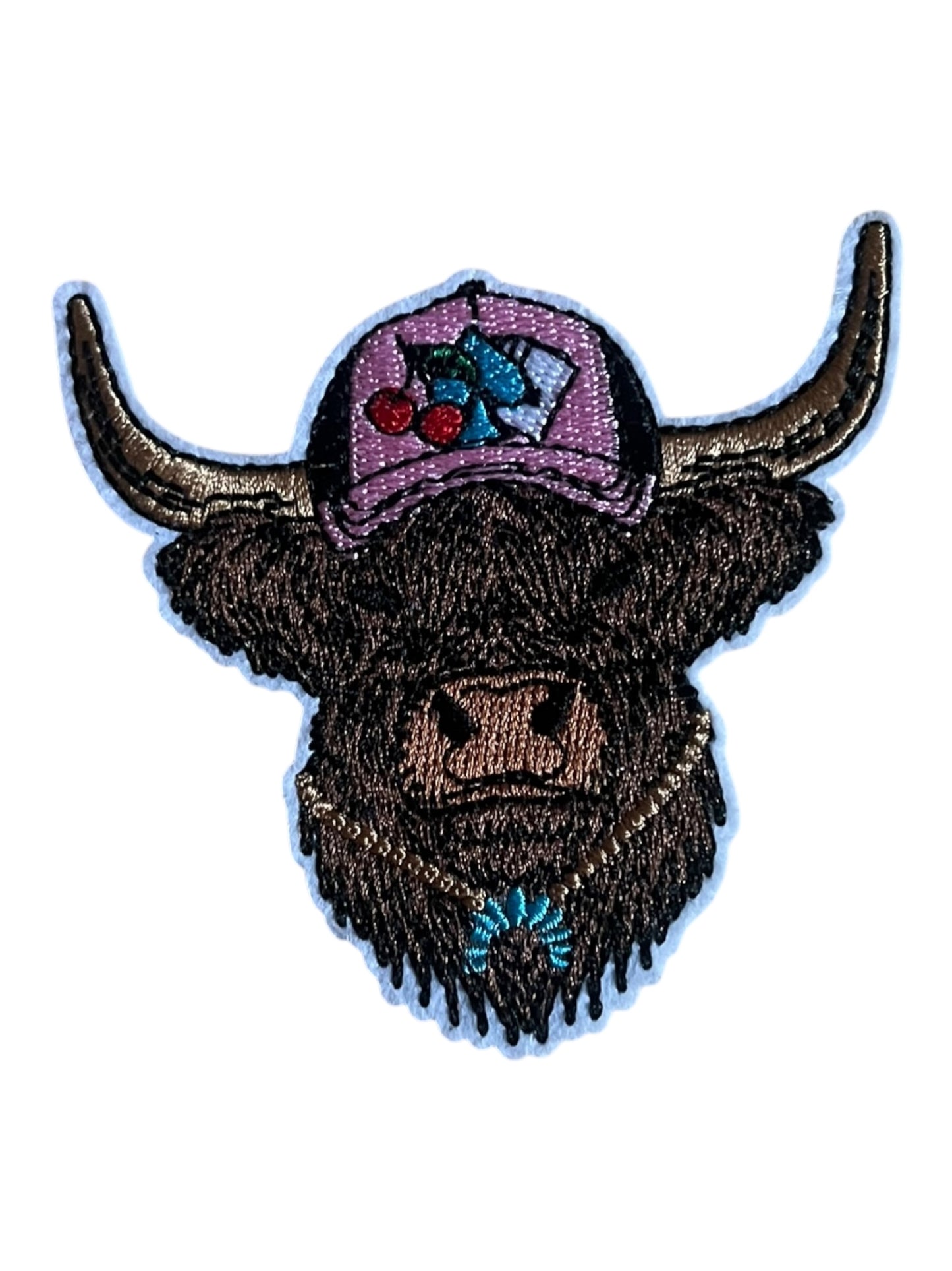 Cow with pink cap and turquoise necklace