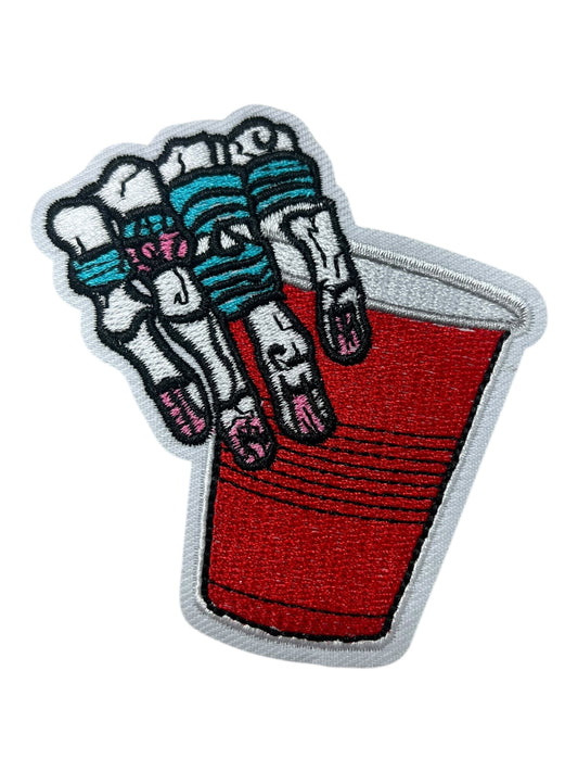Skelly hand with red tumbler