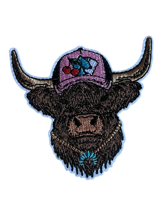 Cow with pink cap and turquoise necklace