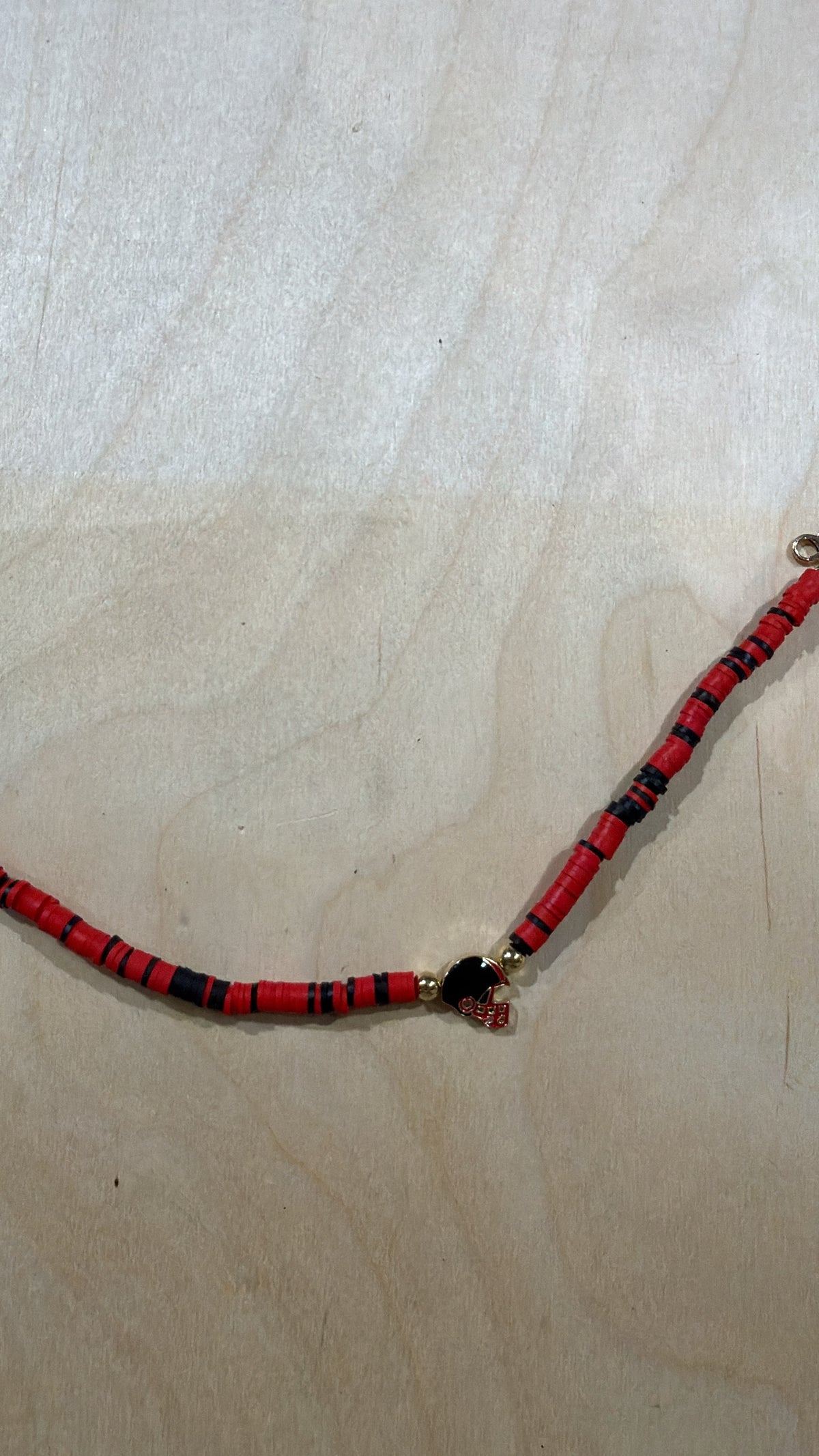 Red and black disc bead hat chain with football