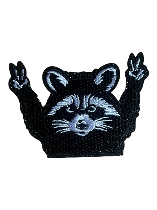 Raccoon with holding peace fingers