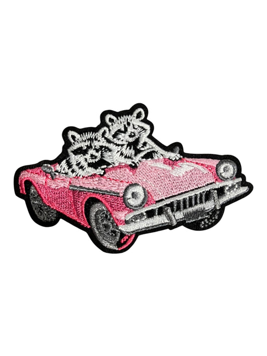 Pink car with raccoons
