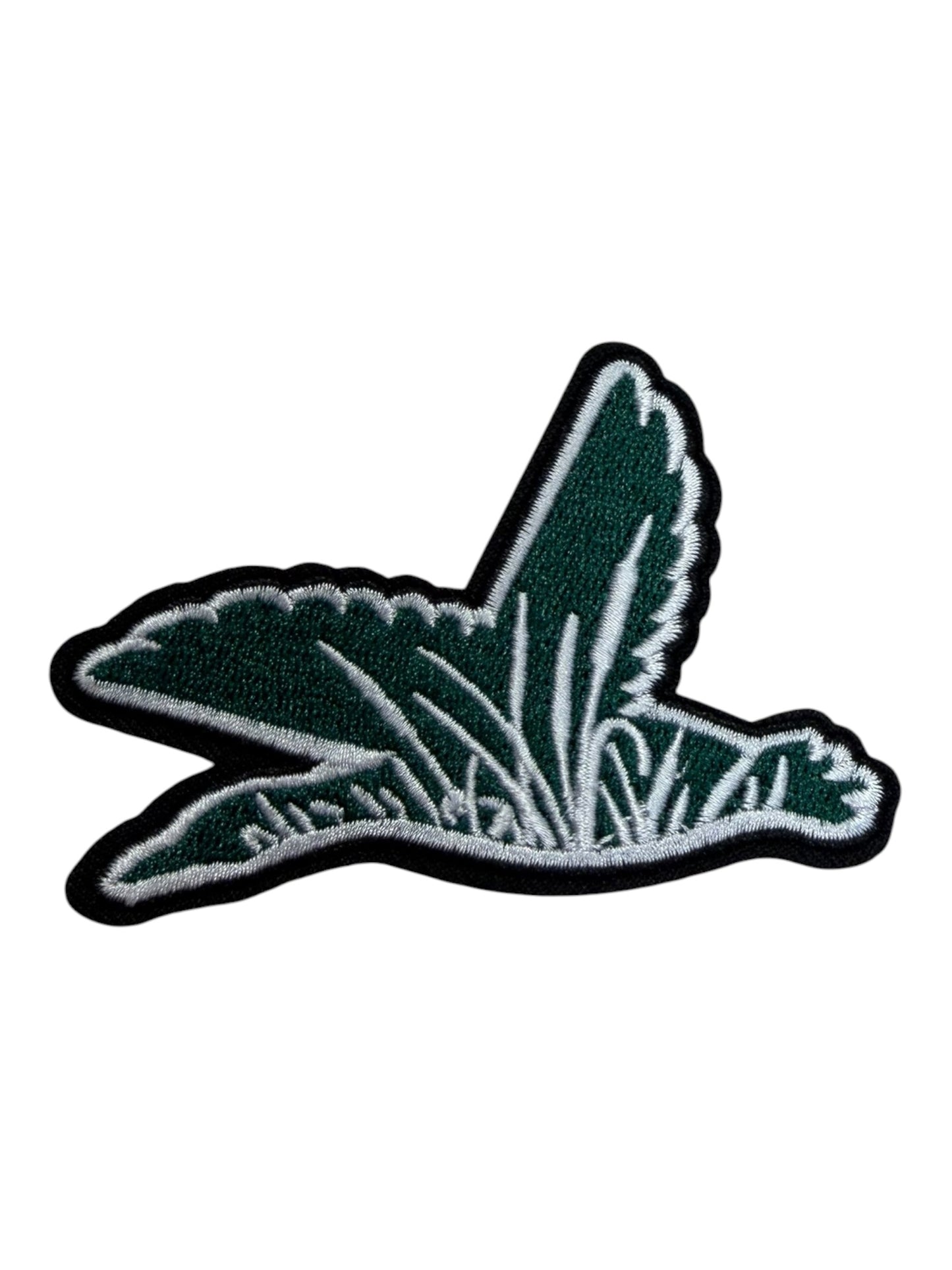 Green duck with cattails and grass