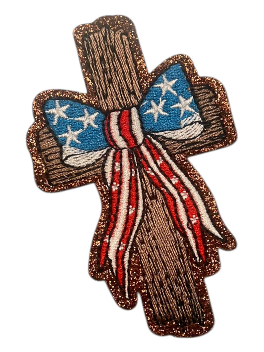 Wooden cross with red white and blue bow